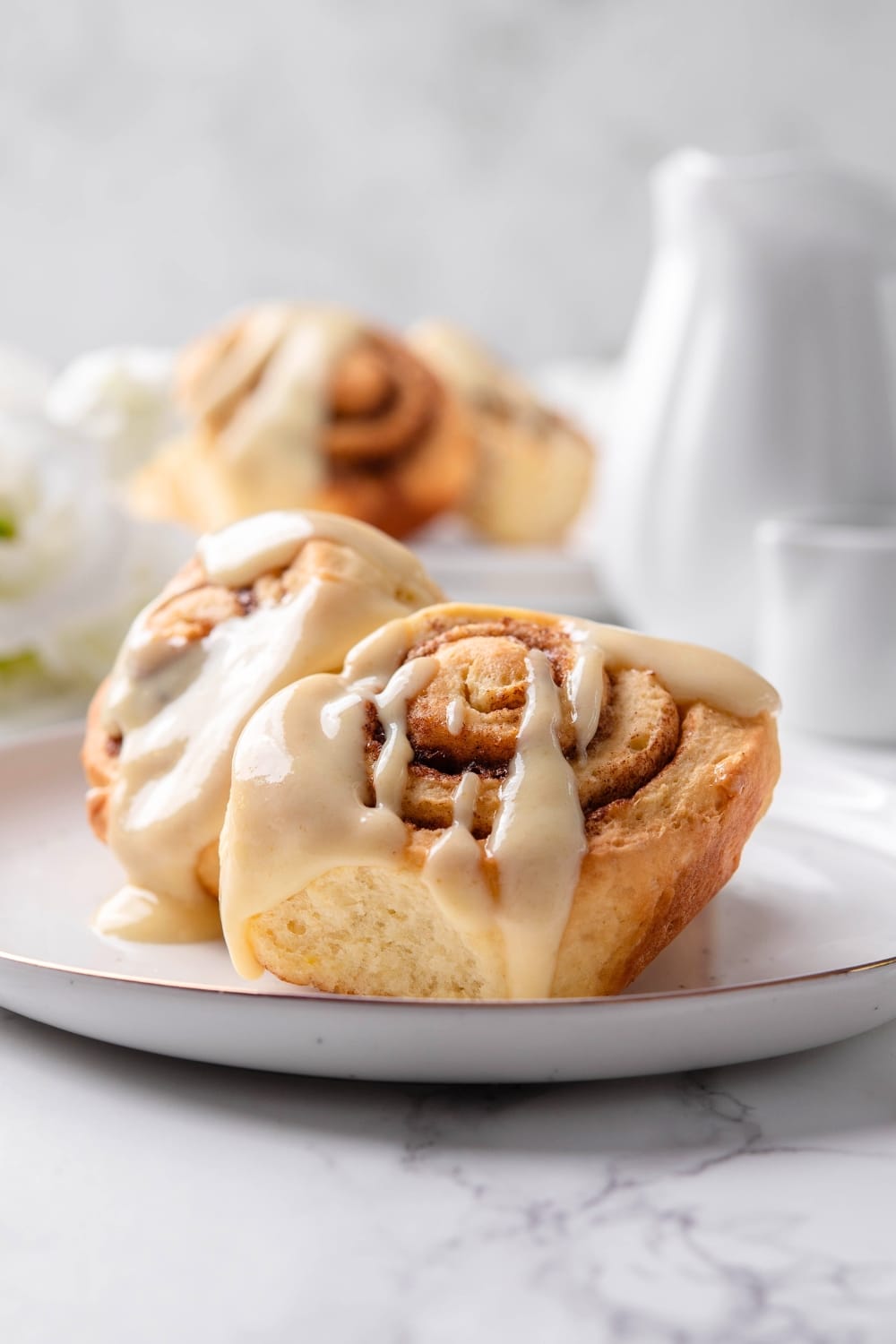Two protein cinnamon rolls on a white plate.