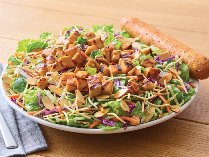 Grilled chicken on a bed of Asian greens, carrots, almonds. and crunchy noodles.