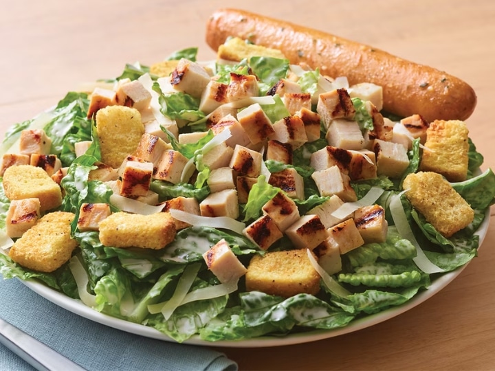 Grilled chicken and croutons on a bed of greens.