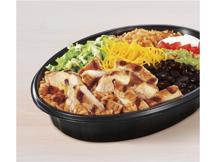 Chicken slices, cheese, lettuce, tomato, black beans, and cheese in a bowl.
