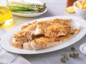 A bunch of pieces of haddock with breadcrumbs on top.
