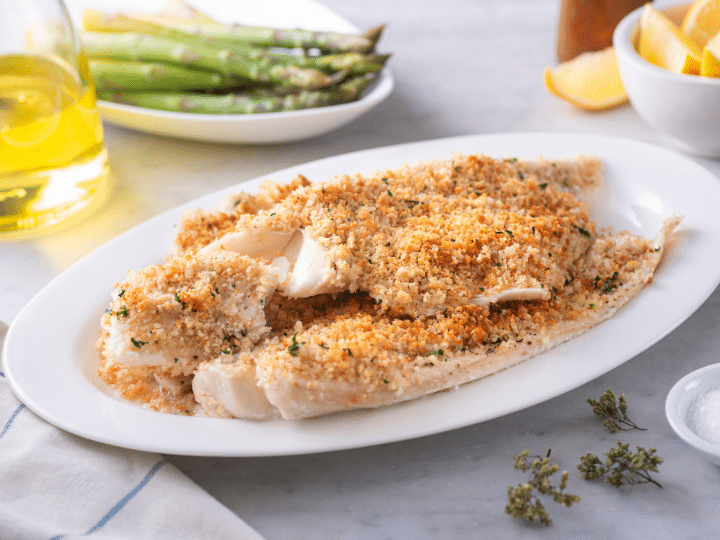 A bunch of pieces of haddock with breadcrumbs on top.