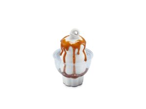Vanilla ice cream with caramel sauce on top in a clear bowl.