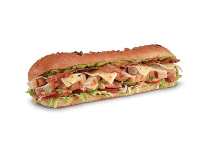 A sub with guac, pepper jack cheese, lettuce, tomato, chicken, and bacon.