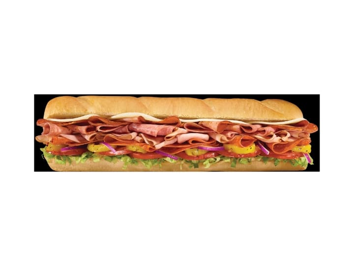 A sub with ham, salami, pepperoni, cheese, peppers, tomato, onion, and lettuce.