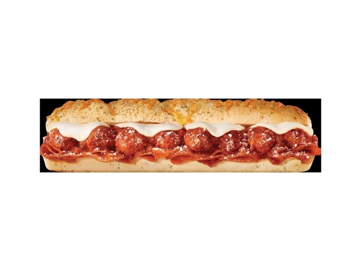 A sub with meatballs, sauce, and provolone cheese.