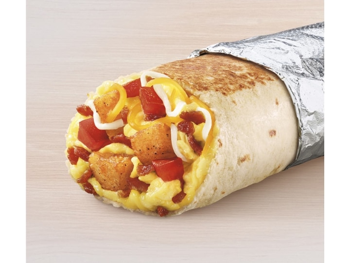 A burrito filled with tater tots, eggs, and bacon.