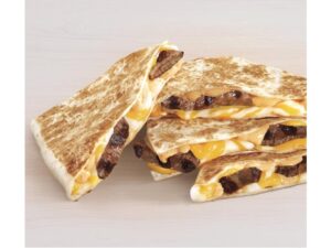Four steak and cheese quesadilla triangles.