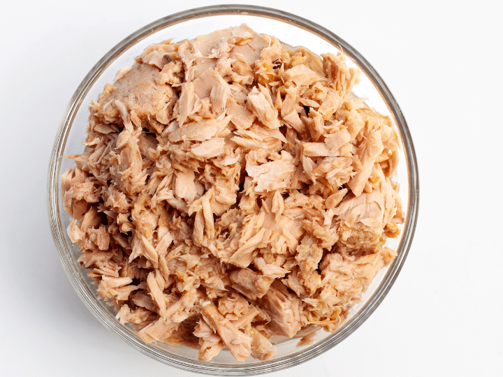 Canned tuna in a glass bowl.