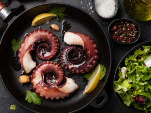 Three pieces of octopus in a skillet.