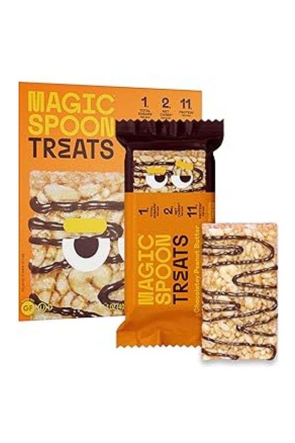 A box of Magic Spoon treats with a wrapped bar and unwrapped bar in front of it.