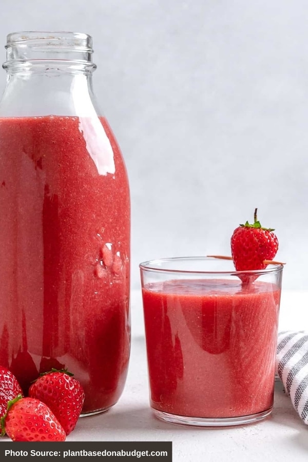 A pitcher and cup of Strawberry Juice.