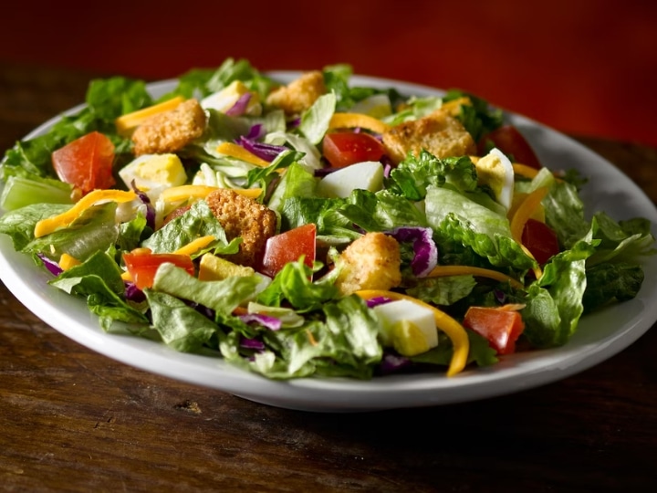 A house salad on a white plate.