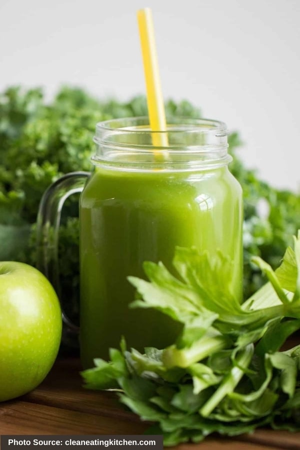 A cup of Vegetable Detox Juice with a straw in it.