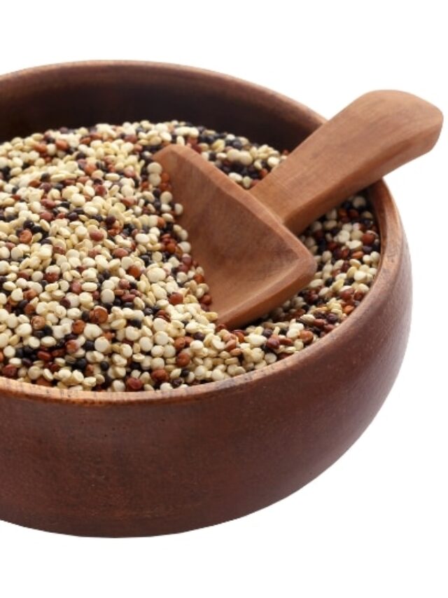 A bowl of quinoa with a wooden spoon in it.