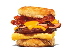 A biscuit with bacon, cheese, ham, sausage, and an egg.