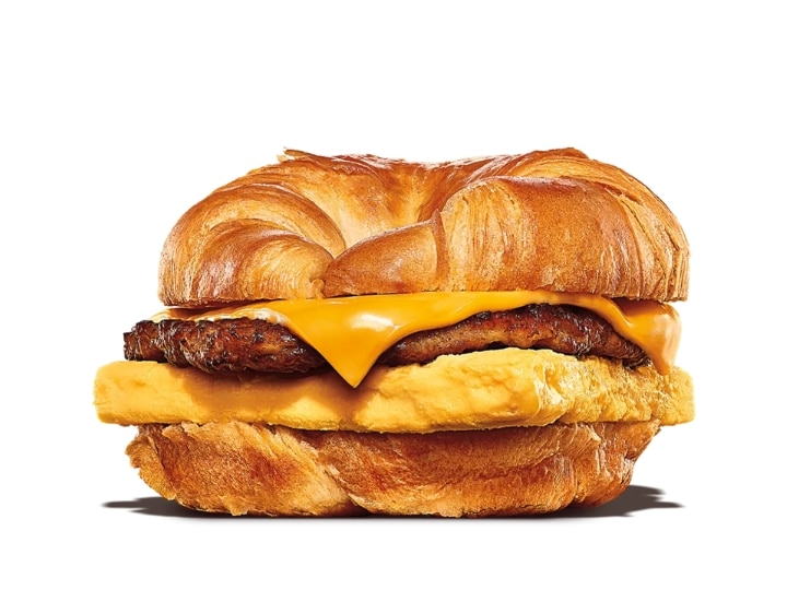 A croissant with sausage, egg, and cheese.