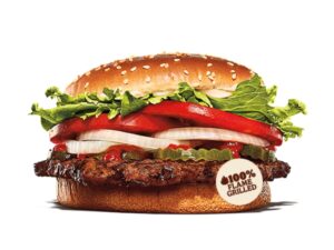 A hamburger with lettuce, onion, tomato, pickles, and ketchup.