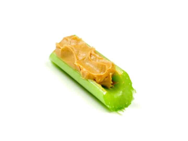 A stick of celery with peanut butter on it.