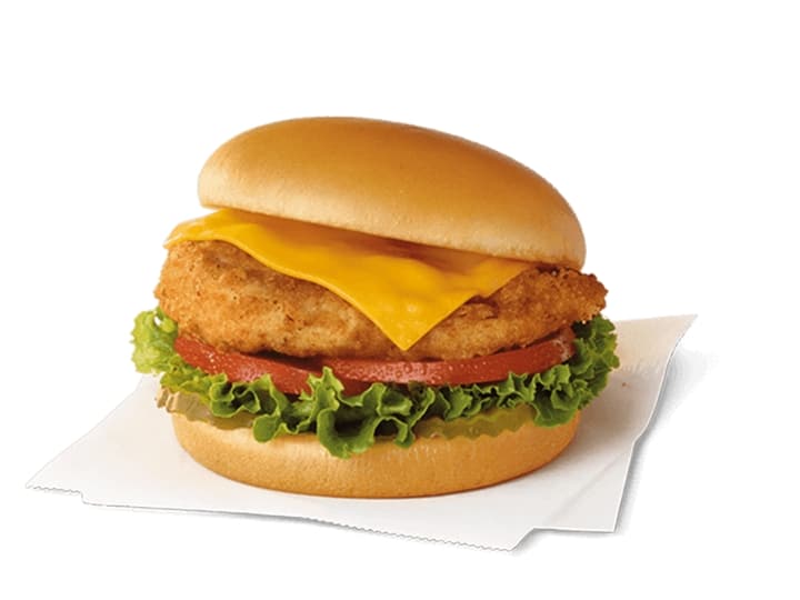 A breaded chicken sandwich with cheese, lettuce, and tomato.