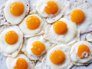 A bunch of sunny side up eggs.