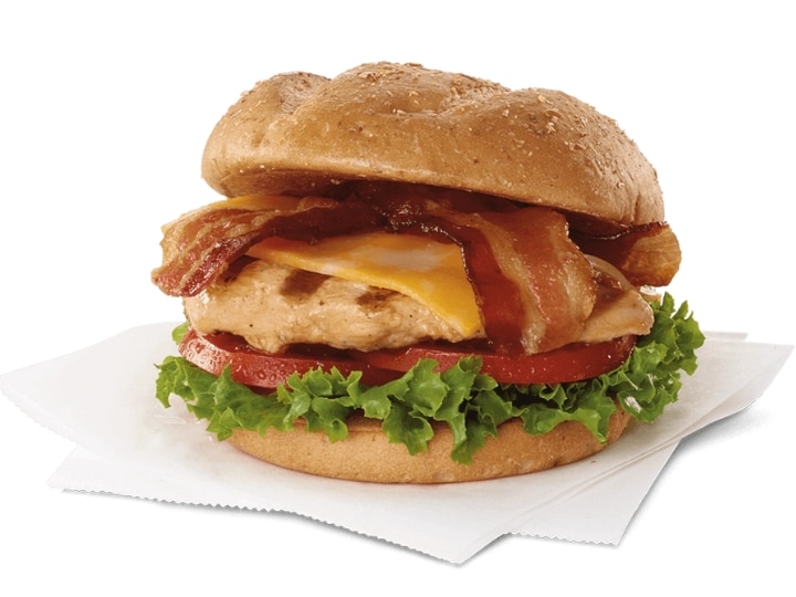 A grilled chicken sandwich with cheese, bacon, lettuce, and tomato.