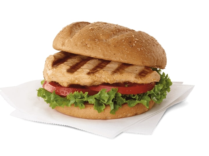 A grilled chicken sandwich with lettuce and tomato.