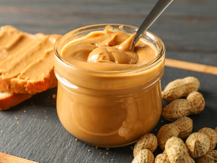 A glass bowl of peanut butter.