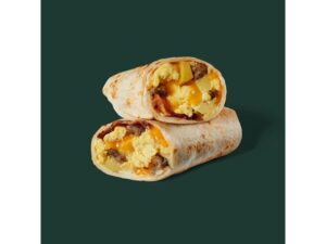 A tortilla wrap cut in half with eggs, bacon, sausage, and cheese in it.