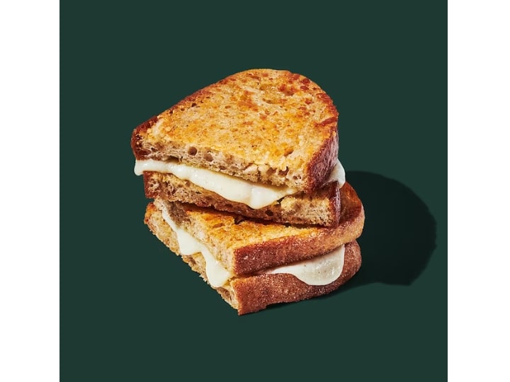 A grilled cheese sandwich sliced in half with the two halves on top of one another.