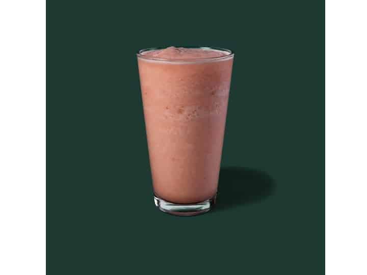 A glass cup of starbucks strawberry lemonade.