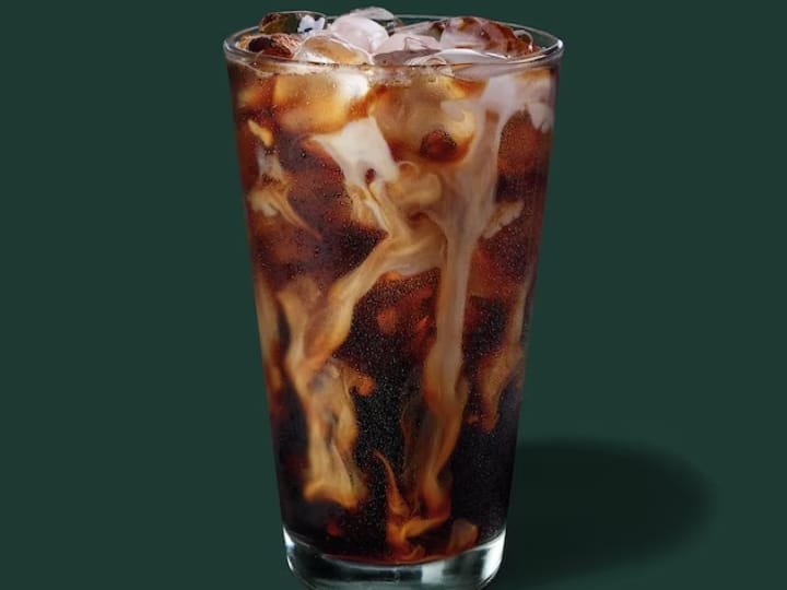 A cup of starbucks cold brew coffee with milk.