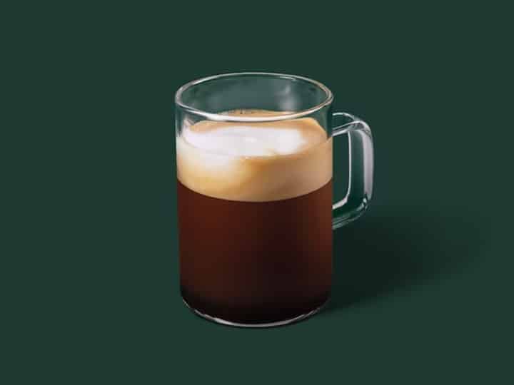 A cup of starbucks espresso macchiato.