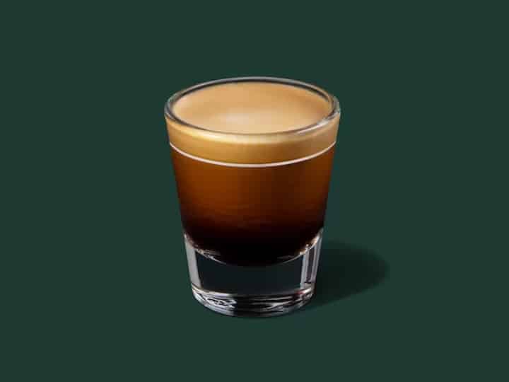 A small shot glass of starbucks espresso.