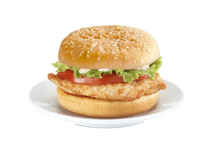 A sesame seed bun with lettuce. tomato, mayo, and grilled chicken.