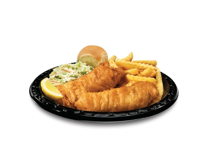 A plate of two breaded cod fillets, french fries, and coleslaw.