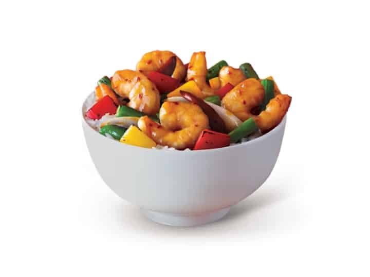 A bowl of firecracker shrimp with green beans and bell peppers.