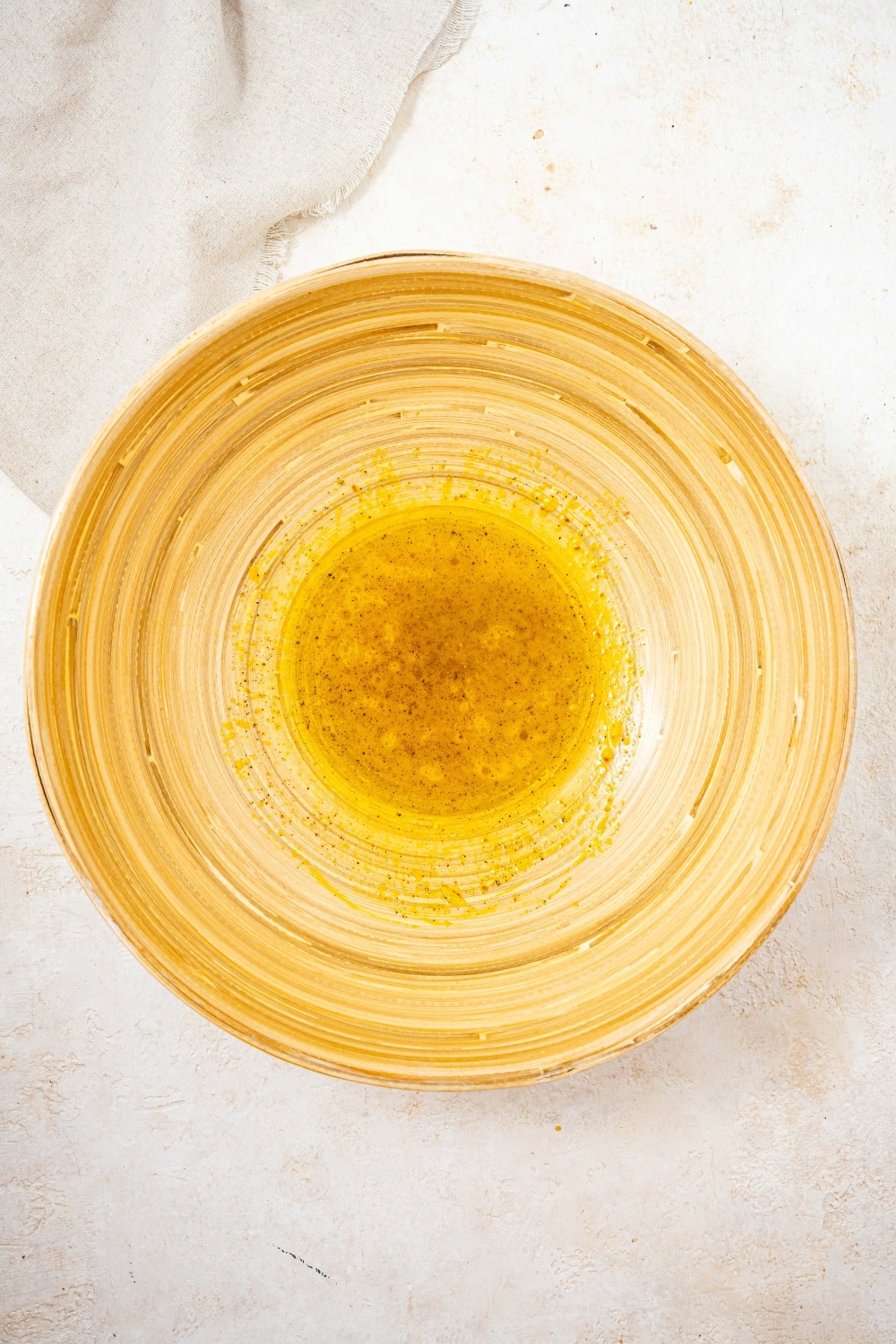 An overhead shot of a large salad bowl filled with salad dressing.