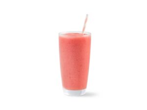A pink smoothie in a glass cup.
