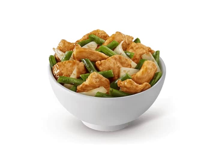 A bowl of chicken and string beans.