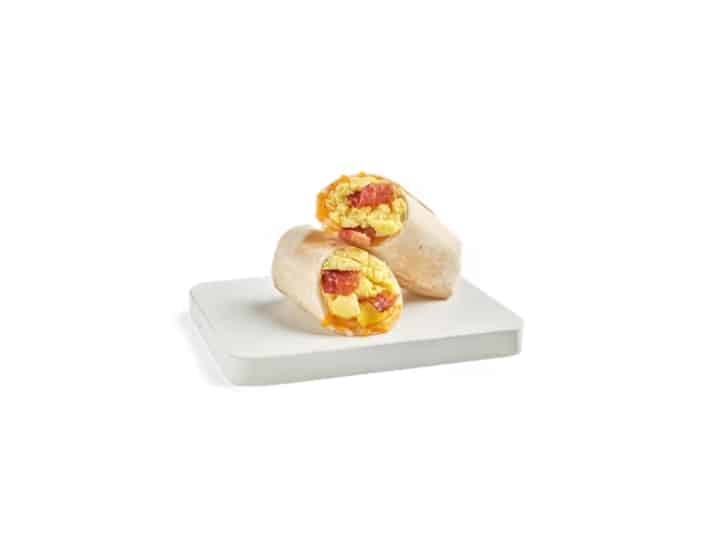 A bacon and egg wrap cut in half.