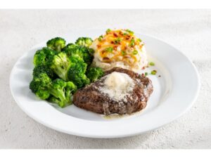 A piece of steak, broccoli, and mashed potatoes on a plate.