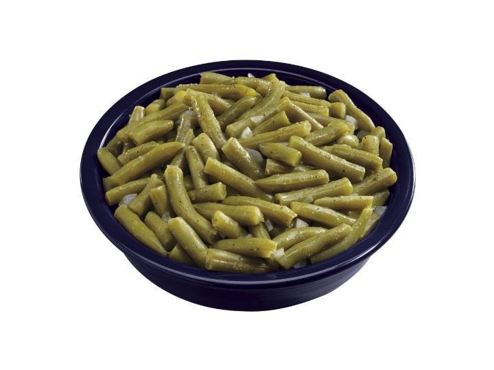 A black bowl filled with green beans.