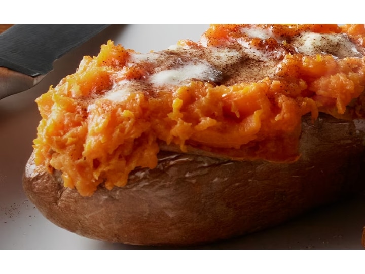 A sweet potato with butter and cinnamon on top.