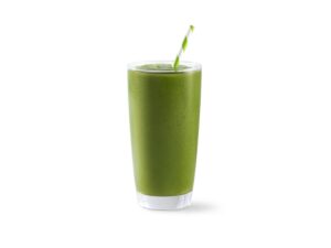 A green smoothie in a glass cup.