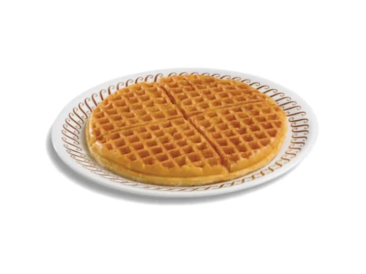 A large waffle house waffle on a white plate.