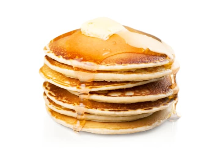 A stack of pancakes with butter and syrup.