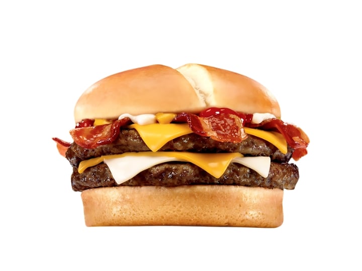 A double cheese burger with bacon and sauce.