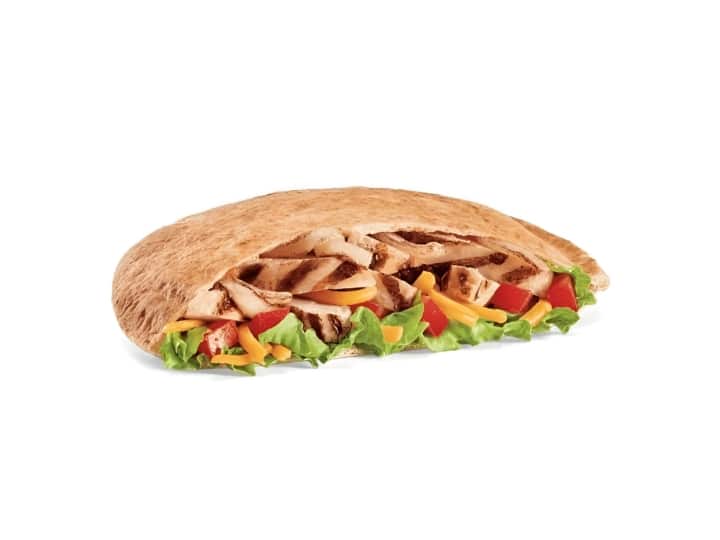 A chicken fajita in a pocket of bread. 