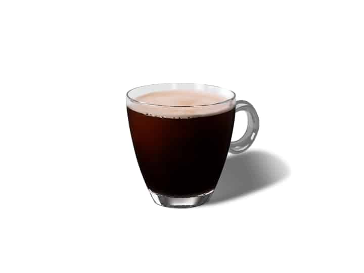 A glass cup filled with an Americano.